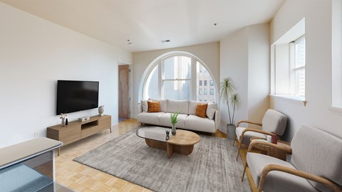 a living room with a large arched window and a couch